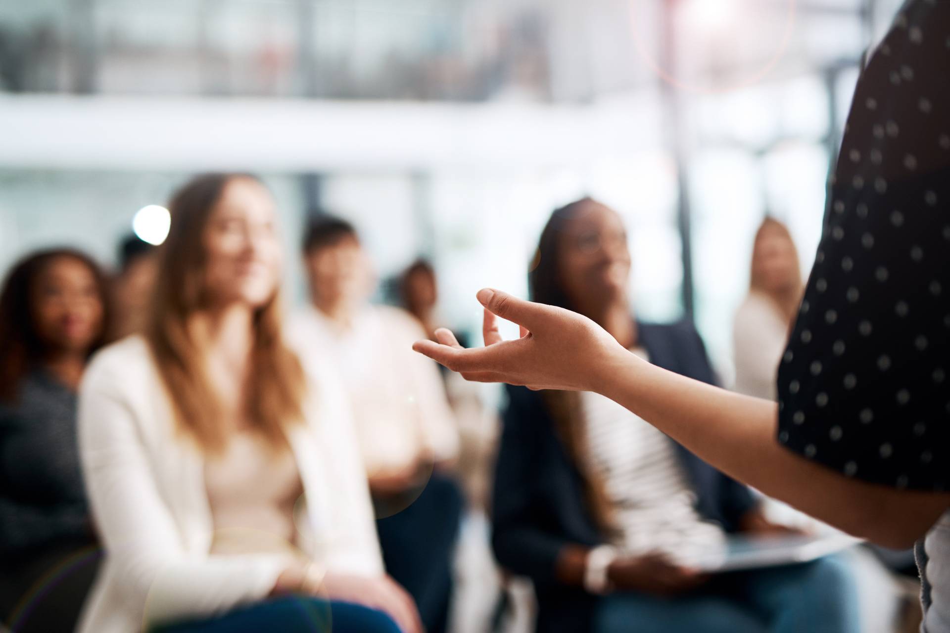 Speaker presenting to an audience in a seminar setting.