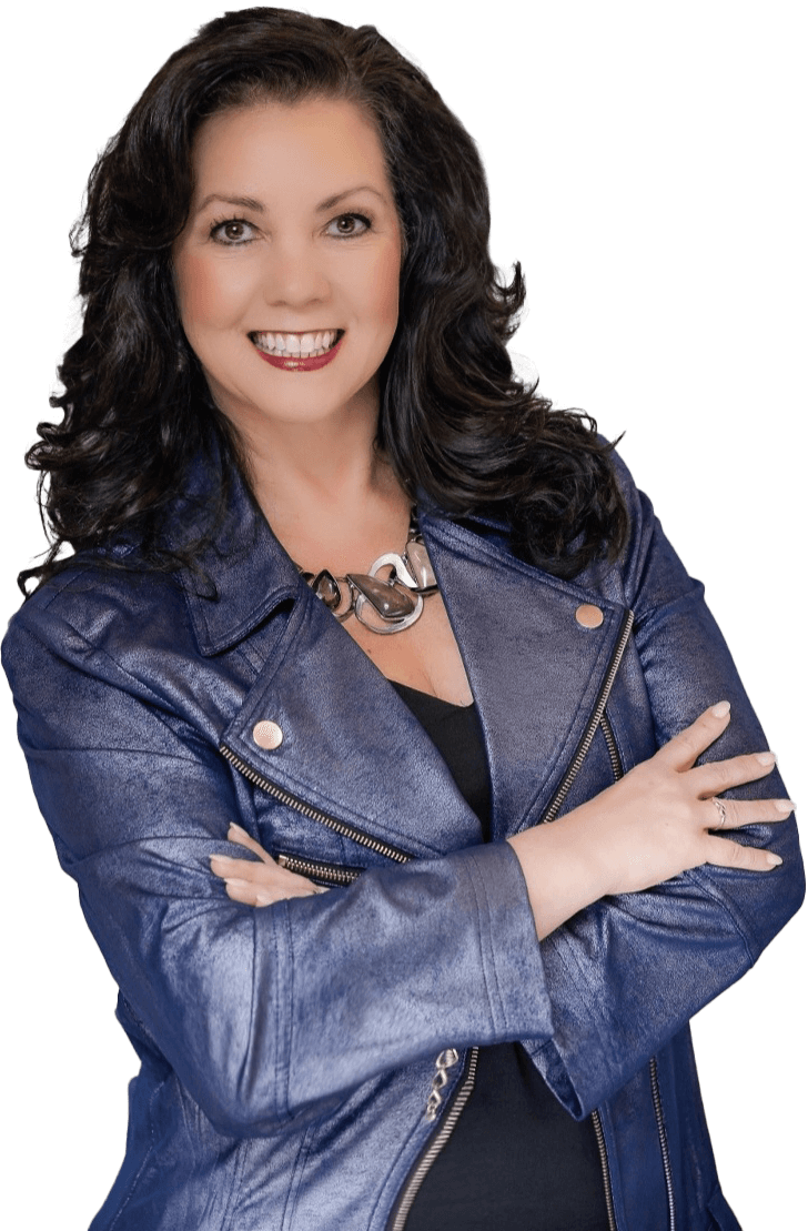 Angela Buttimer, a woman with long, dark hair and a bright smile, is wearing a blue leather jacket and a chunky necklace while crossing her arms.