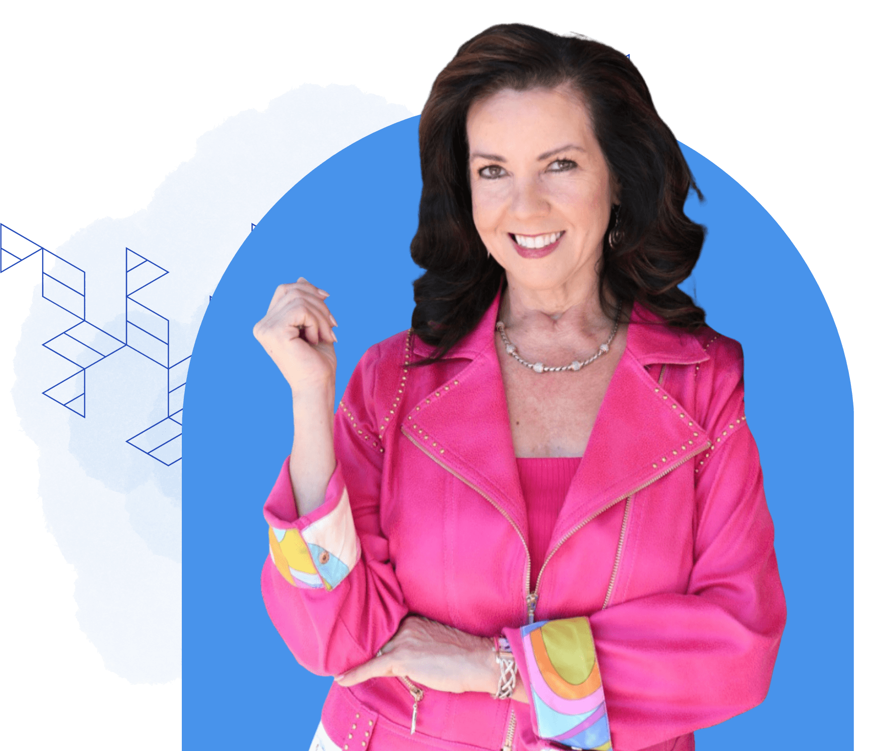 A woman with long dark hair smiles while wearing a bright pink jacket over a pink top, standing in front of a blue and white background with geometric patterns, adding a lively touch to the setting all about bold color and style.