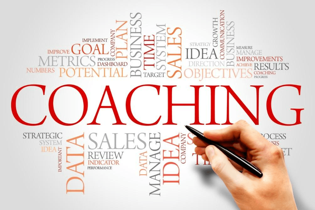 A hand writes "COACHING" in large red letters, surrounded by business-related words like "GOAL," "SALES," and "POTENTIAL." The scene highlights how Executive Function Coaching builds practical skills to help you thrive at work.